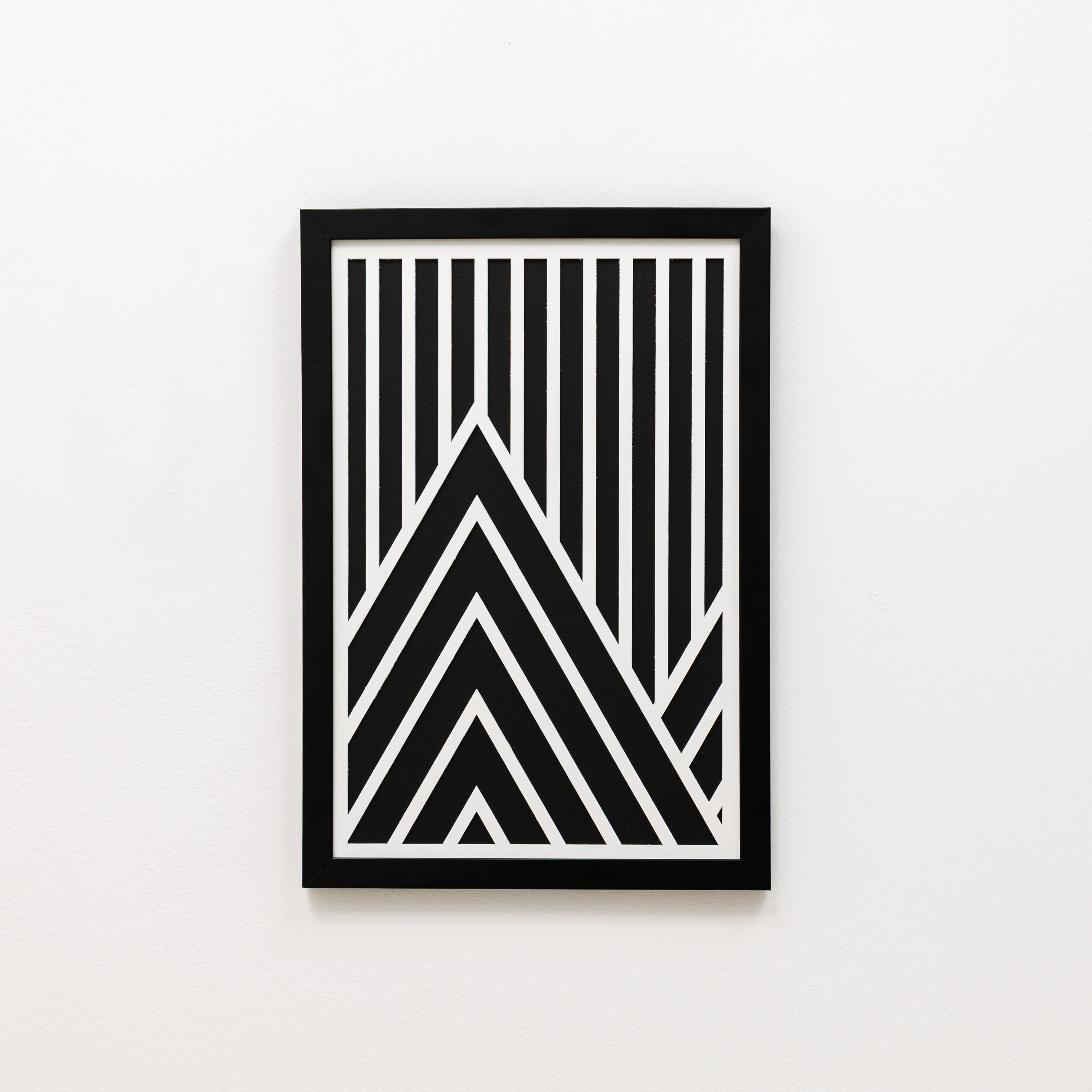 Framed black and white geometric art print on a light gray background
