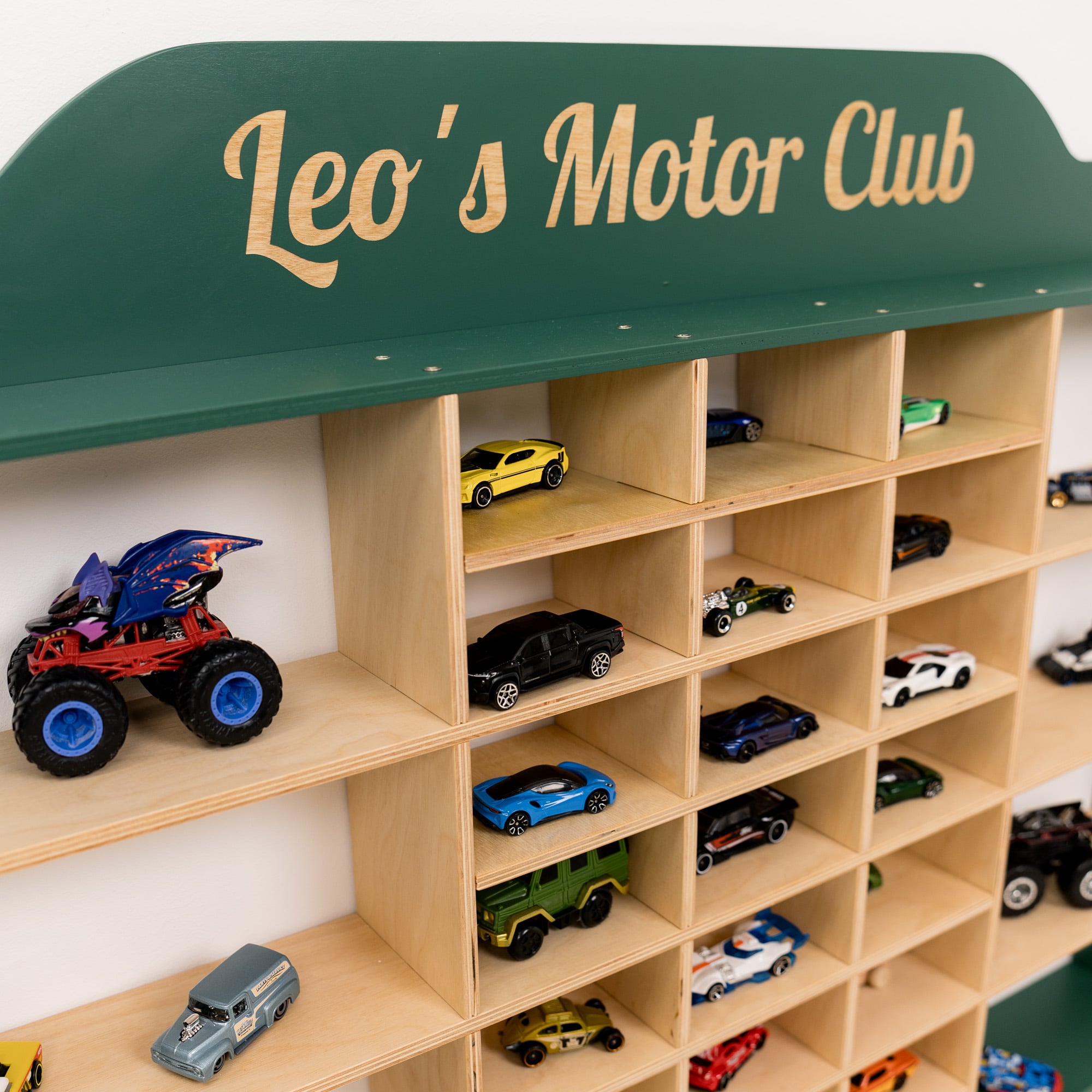 Wooden toy car display case with 'Leo's Motor Club' sign and various toy cars.