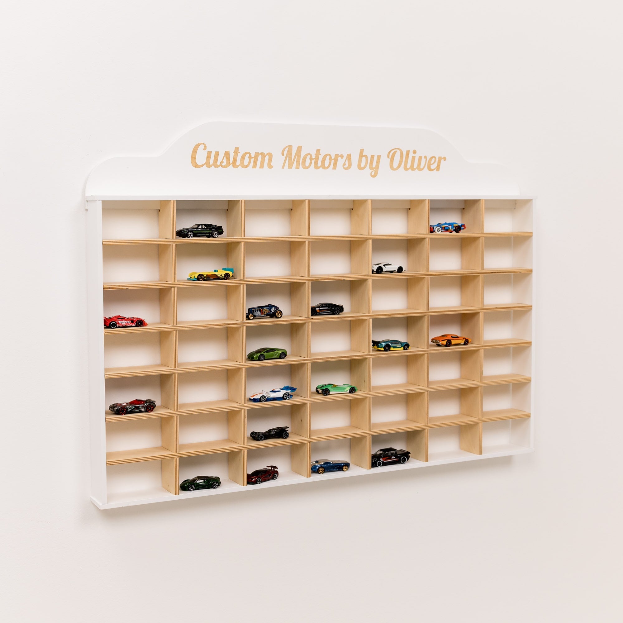 Wooden shelf with model cars and 'Custom Motors by Oliver' branding on a white background