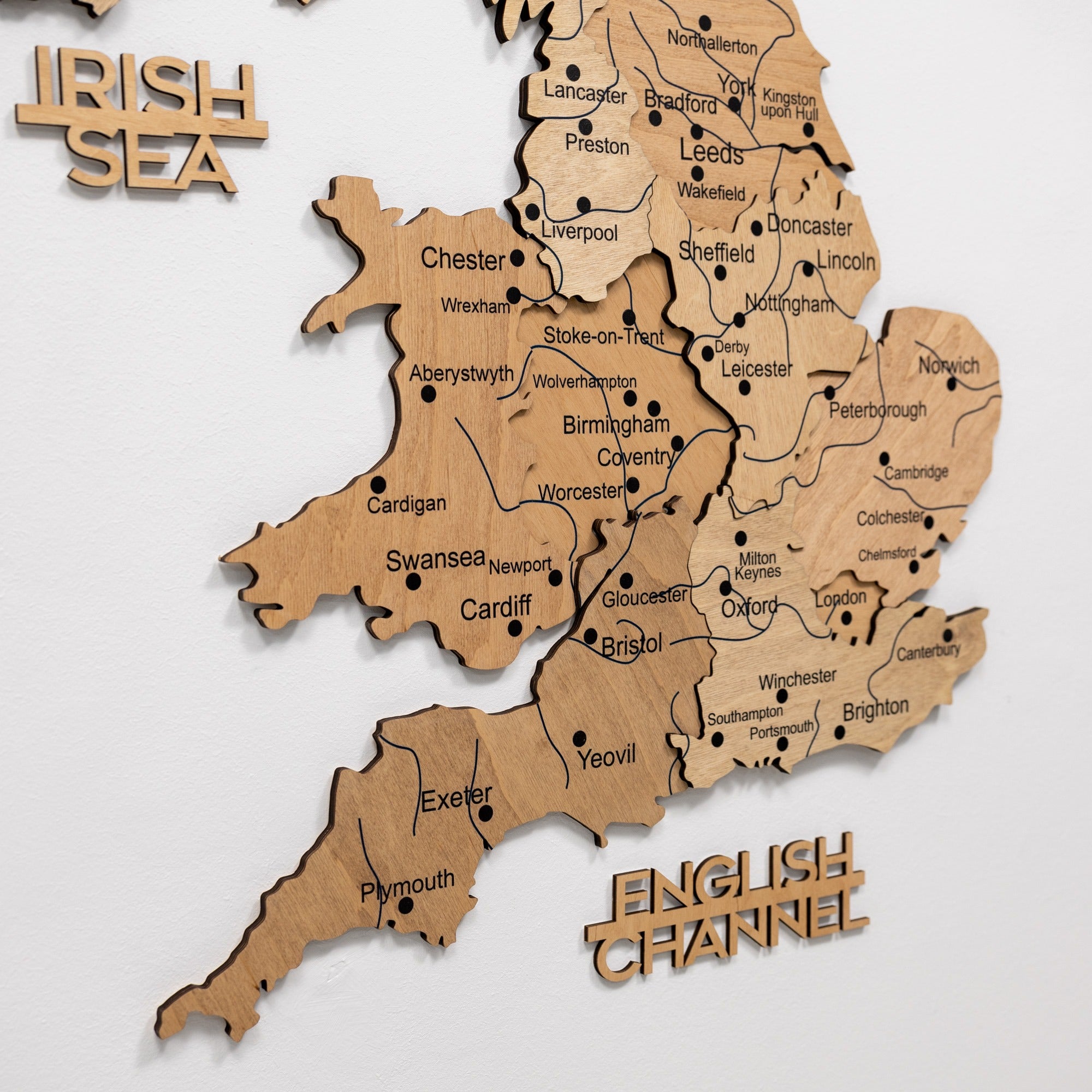 Wooden map of England with cities labeled on a white background