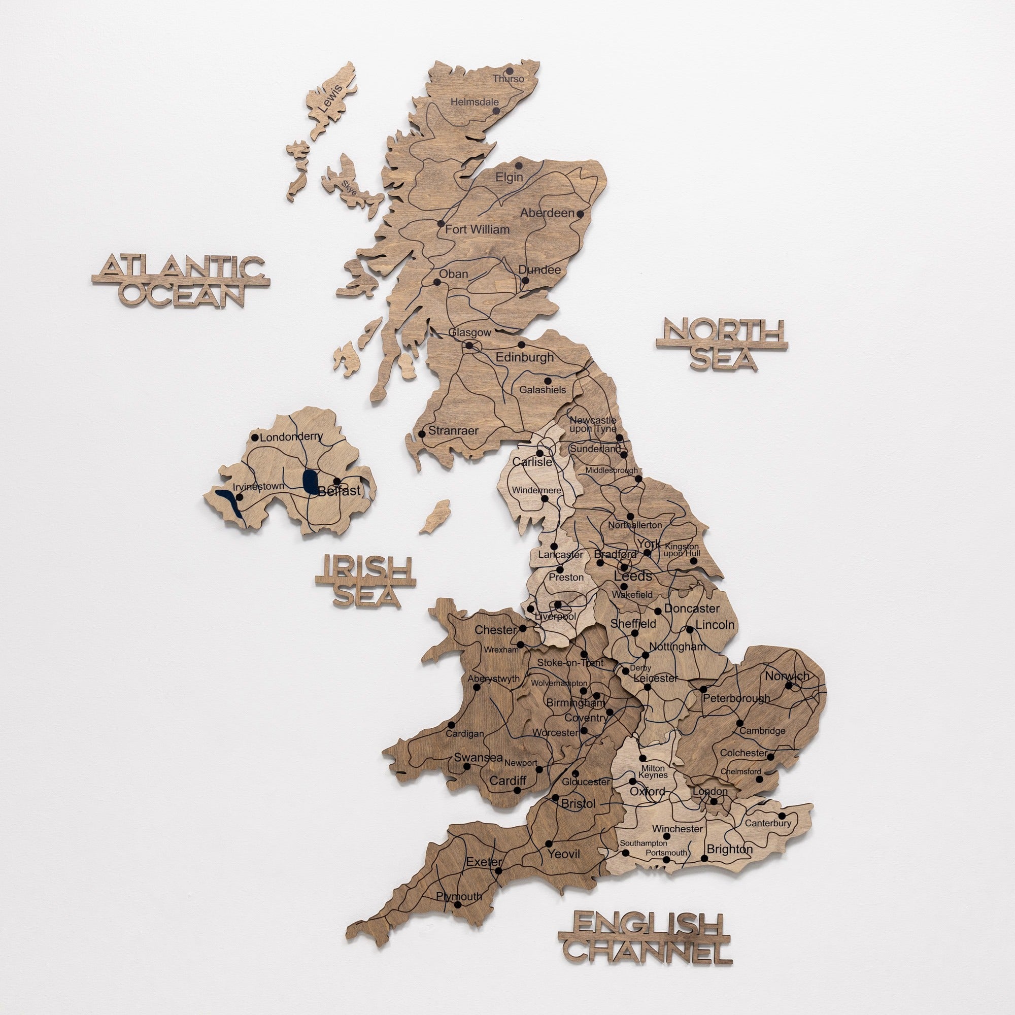 Wooden map of the United Kingdom with labeled seas and countries on a white background
