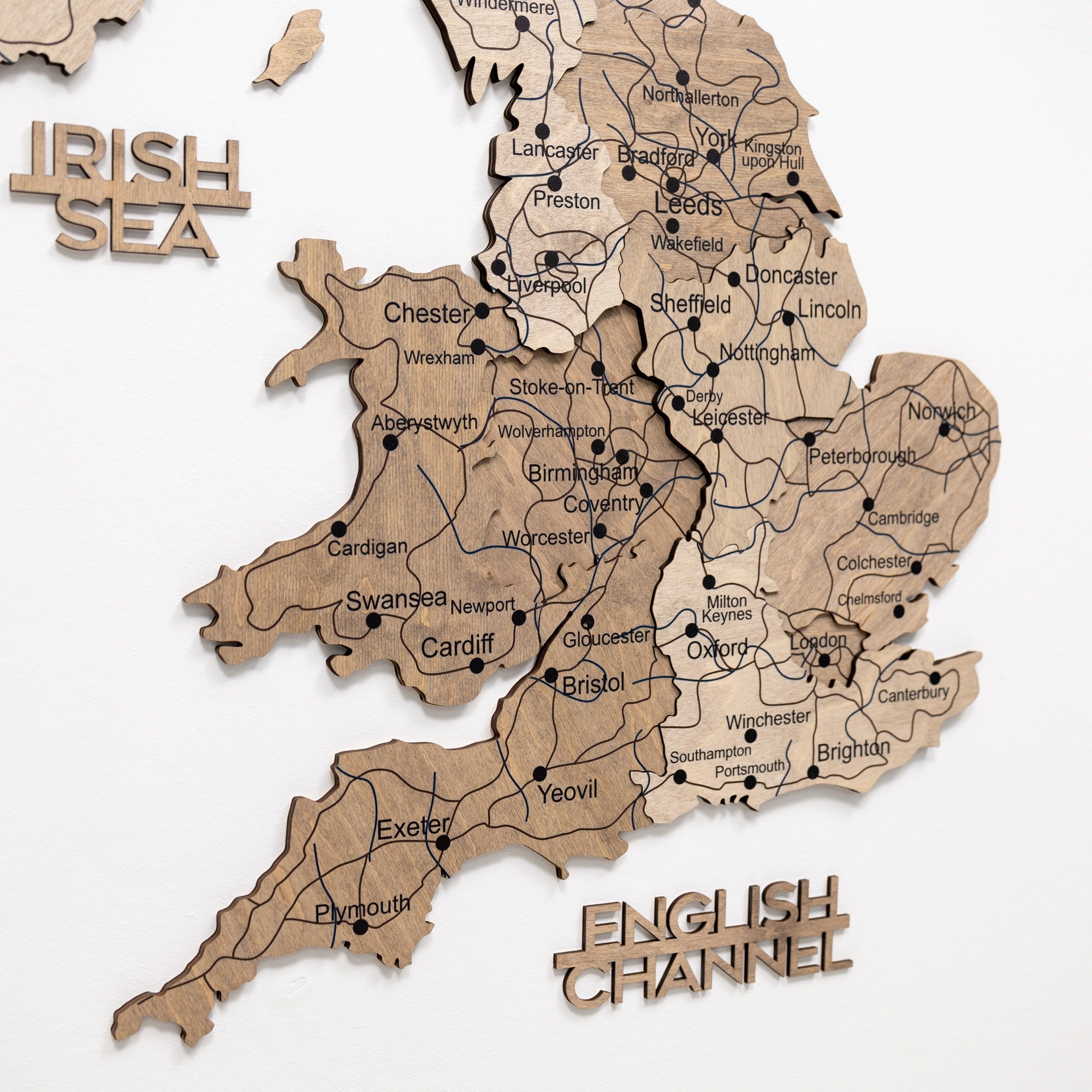 Wooden map of England with cities labeled on a white background