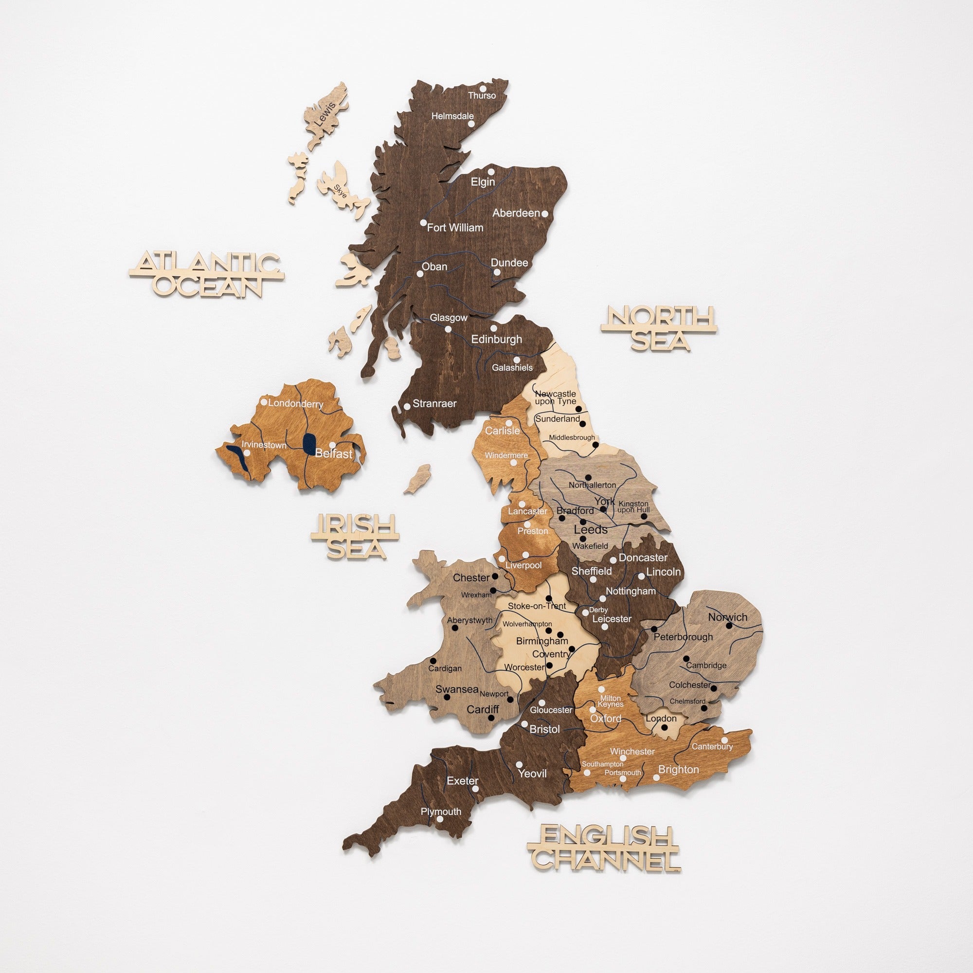 Wooden map of the United Kingdom with different shades of brown on a white background