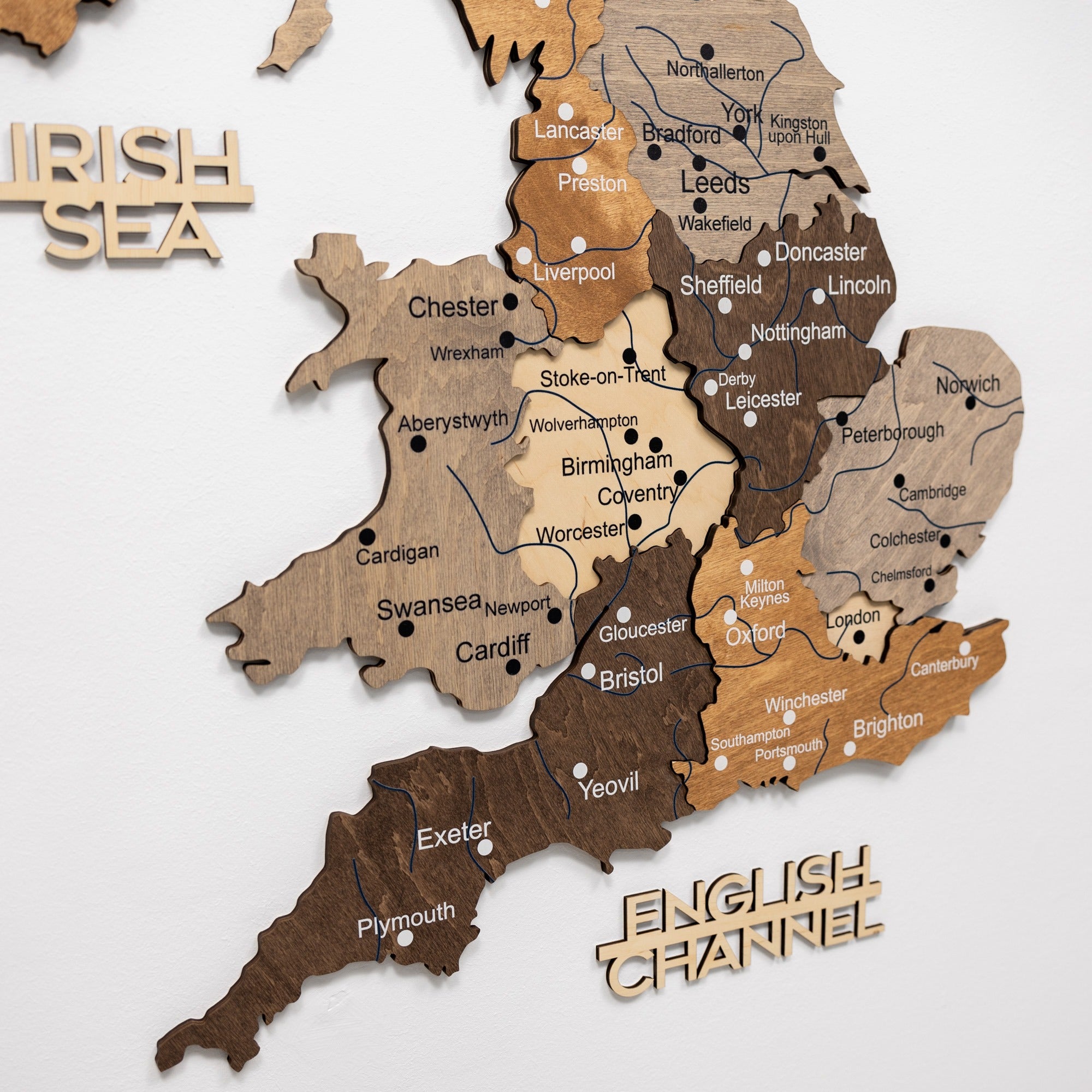 Wooden map of England with cities labeled on a white background