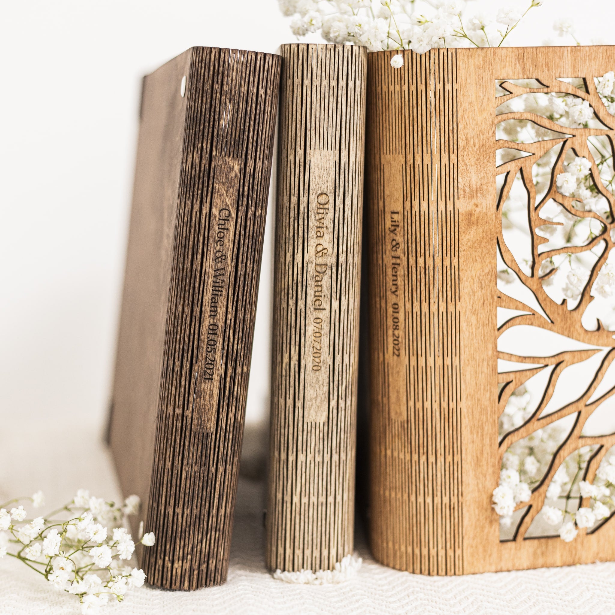 Wooden bookends with engraved text and floral design on a white background